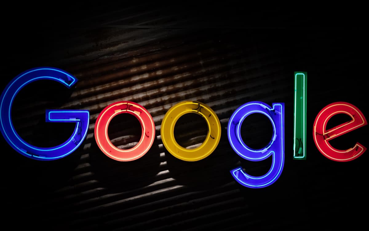 Google neon sign glowing in brand colors against a dark background